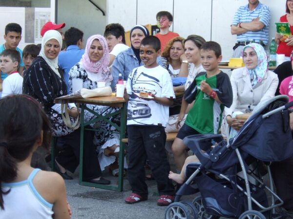 Muslim Women And Children Watching Program In Austrian Park Area